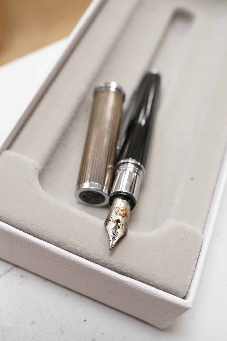 A group of five fountain pens and ballpoint pens